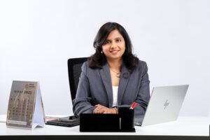 lady sitting at an office desk with a laptop open 